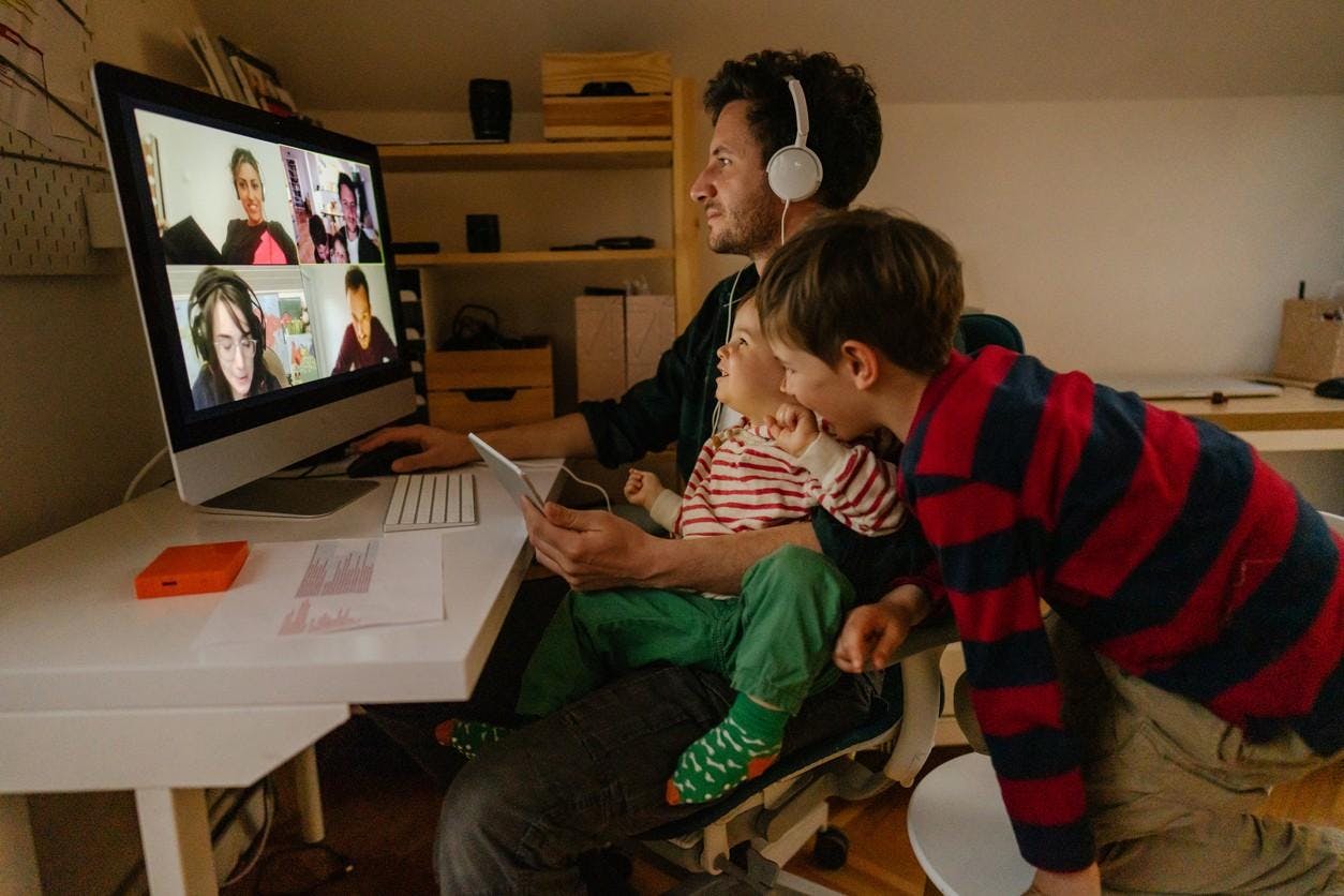 Father with two kids videochatting