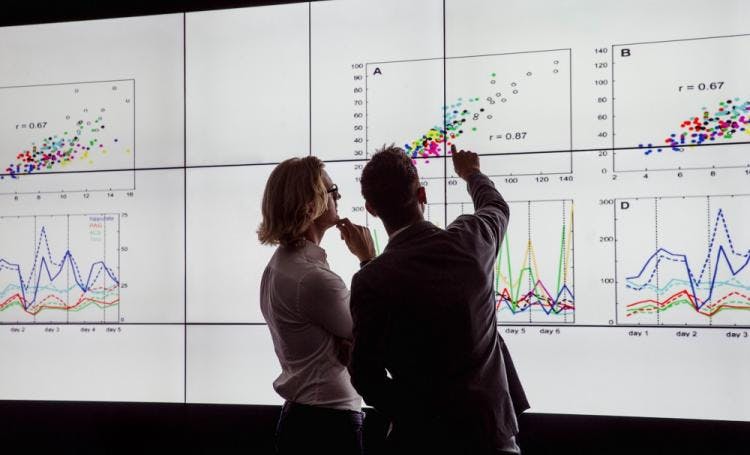 Two people looking at charts