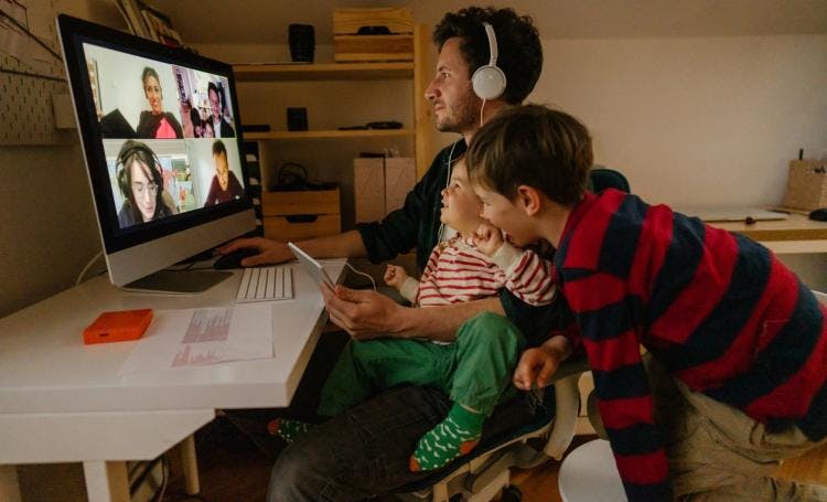 Father with two kids videochatting
